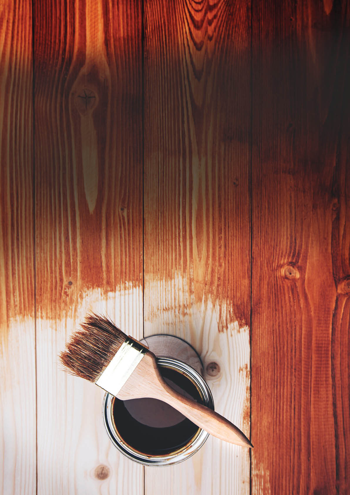 Varnishing a wooden shelf using paintbrush
