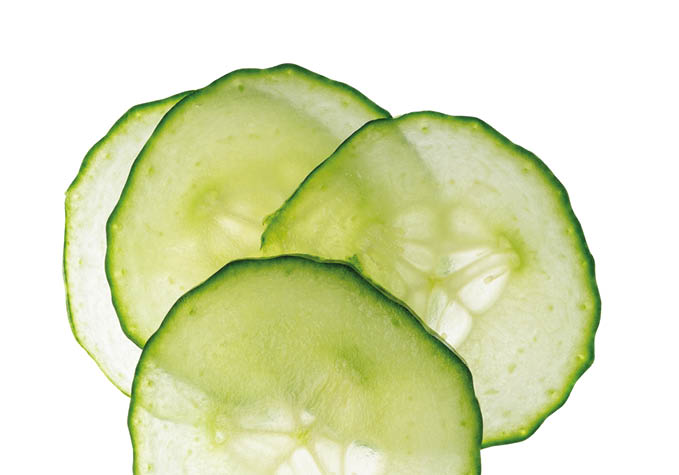 Cucumber cut isolated, cucumber round slices, green vegetable cuts for salad isolated, healthy natural plant pieces, macro cucumbers slicing on white background top view
