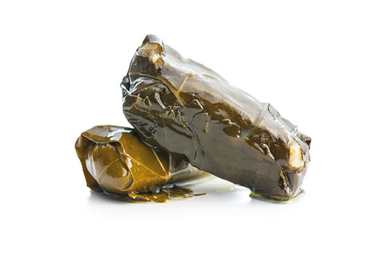 Dolmades. Stuffed vine leaves. Greek appetizer isolated on a white background.