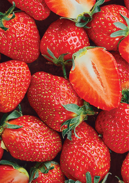 Strawberries cut in half and whole berries, ripe berries top view. Background of ripe strawberries, delicious natural dessert