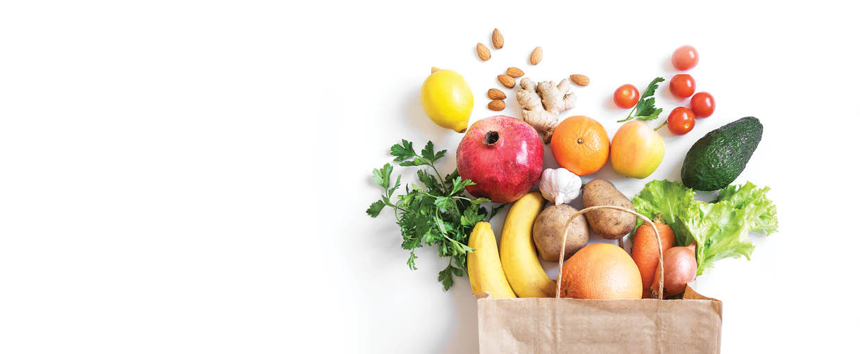 Healthy food background. Healthy vegan vegetarian food in paper bag vegetables and fruits on white, copy space, banner. Shopping food supermarket and clean vegan eating concept.