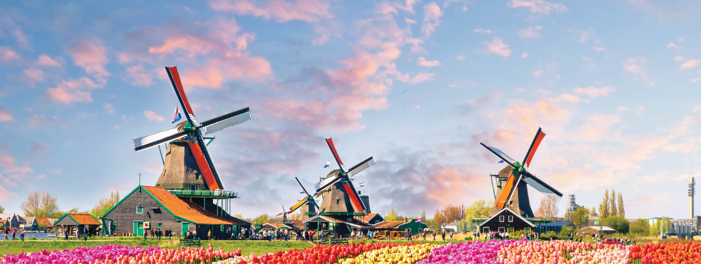 Traditional dutch windmills and houses near the canal in Zaanstad village, Zaanse Schans, Netherlands, Europe