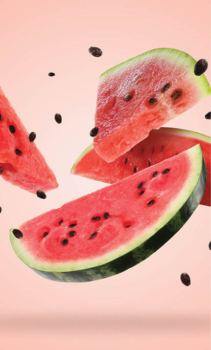 Slices of fresh juicy watermelon falling on pink background
