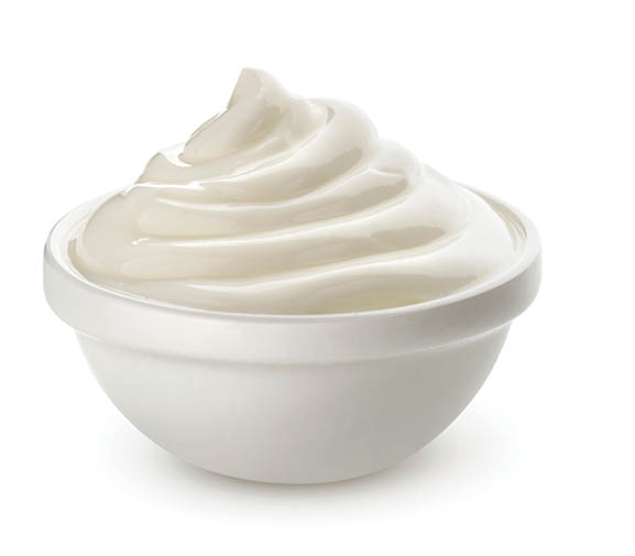 Swirl of sour cream in bowl isolated on white background with clipping path, fresh greek yogurt