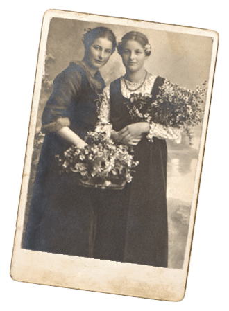 portrait of two young women with flowers. vintage sepia picture ca. 1920