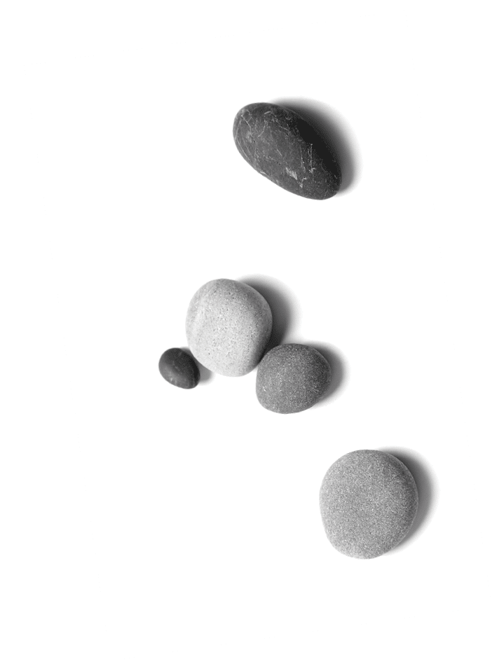 Scattered sea pebbles. Smooth gray and black stones isolated on white background. Top view