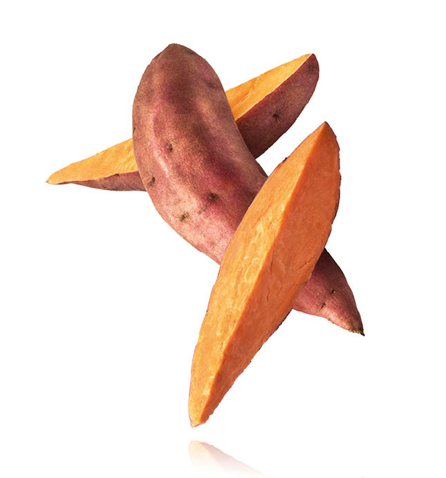 Fresh raw sweet potato falling in the air isolated on white background. Food levitation concept. High resolution image