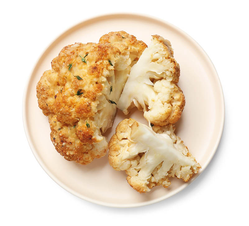 Delicious baked cauliflower isolated on white, top view